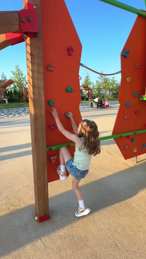 A child successfully climbs up an alpine grid in a park on a playground  Stock Footage 244949115