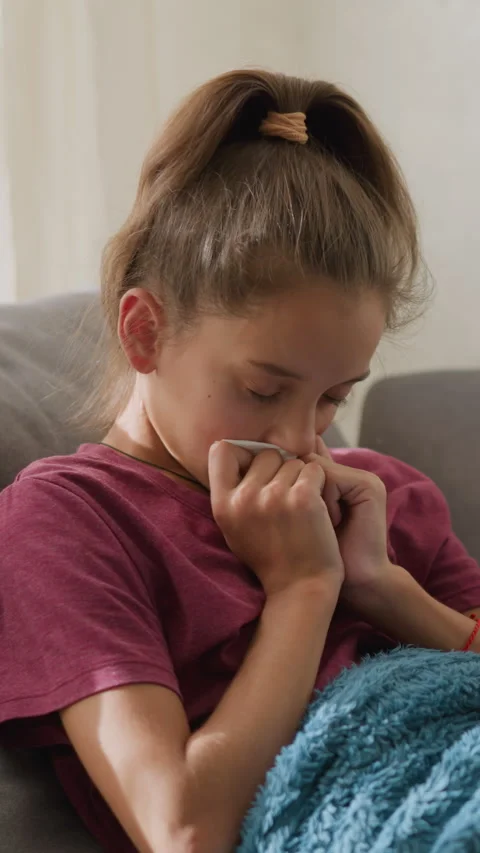 Child Suffering from Flu Sneezing into Tissue with Natural Light Filtering Stock-Footage 320363101