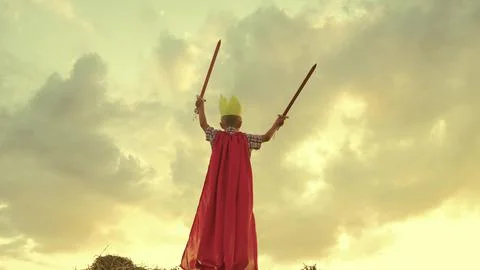 Child superhero game sunset. red cape childish fantasy. countryside. golden Stock Photos