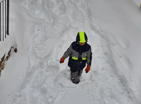 Child surrounded by snow. Stock Photos