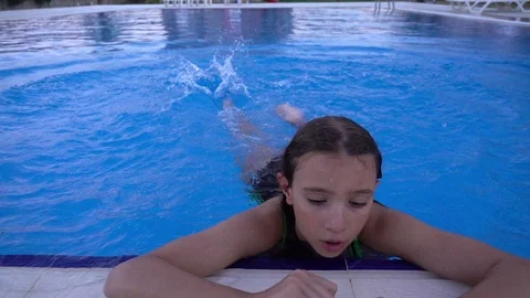Child is in Swimming Pool Stock Footage 93758694