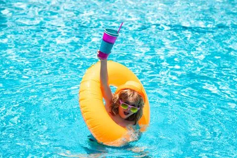 Child in swimming pool on inflatable float ring. Water toy, healthy outdoor Stock Photos