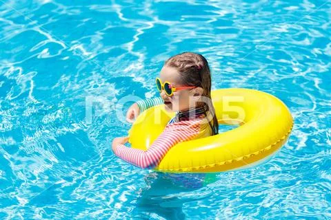 Child in swimming pool. Kids swim. Water play. Stock Photos
