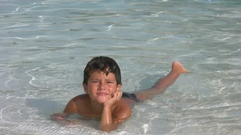 Child in swimming pool smiling to a camera Stock Footage 41817466