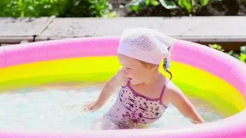 A child swims in an inflatable pool Stock Footage 113502394