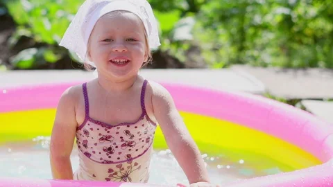 A child swims in an inflatable pool Stock Footage 113897917