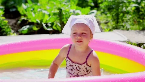 A child swims in an inflatable pool 스톡 동영상 114062618