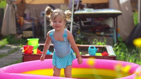 A child swims in an inflatable pool Stock Footage 114211806