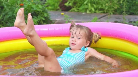 A child swims in an inflatable pool Stock Footage 114261285
