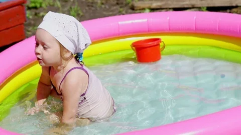 A child swims in an inflatable pool Stock Footage 116243758