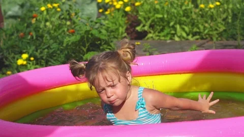 A child swims in an inflatable pool Video stock 116478250