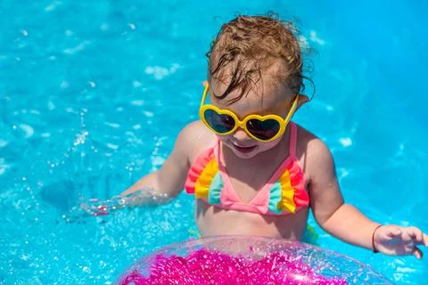 A child swims in a pool with a circle. Selection focus. Stock Photos