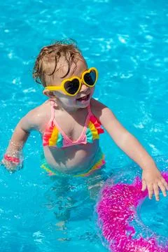 A child swims in a pool with a circle. Selection focus. Stock Photos