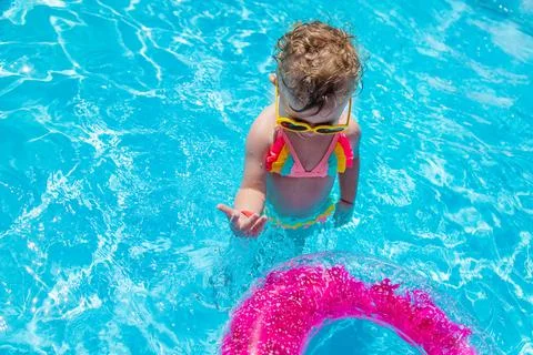 A child swims in a pool with a circle. Selection focus. Stock Photos