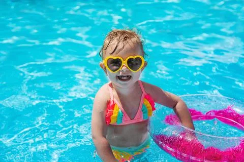 A child swims in a pool with a circle. Selection focus. Stock Photos