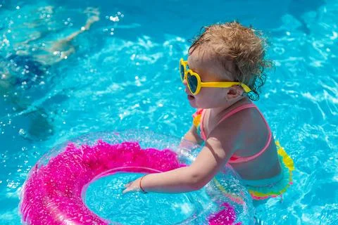 A child swims in a pool with a circle. Selection focus. Stock Photos