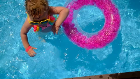 A child swims in a pool with a circle. Selective focus. Stock Footage 201291932
