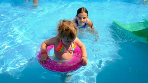 A child swims in a pool with a circle. Selective focus. Stock Footage 201842434
