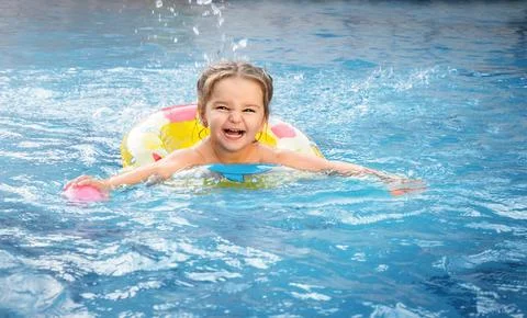 Child swims in the pool Stock Photos