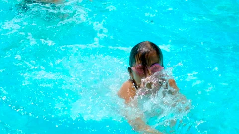 The child swims in the pool. Selective focus. Stock Footage 245606372