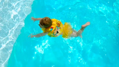 The child swims in the pool. Selective focus. Stock Footage 245606741