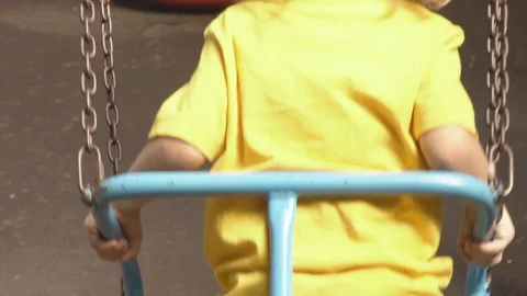 Child on a swing alone in the park Stock Footage 115730465