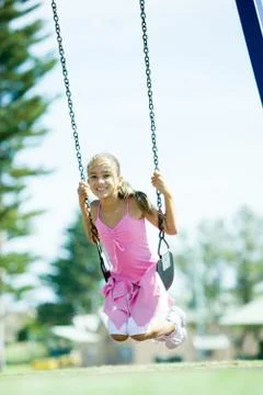 Child on swing Fotos de archivo