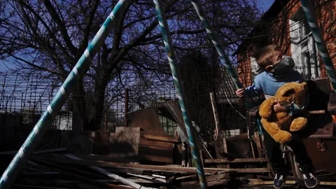 Child on a swing with a toy bear Stock Footage 154426950