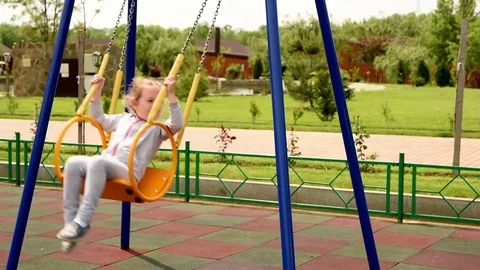 Child swinging on a swing Stock Footage 75836668