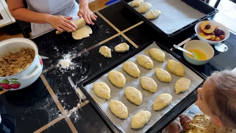 A child is at a table creating bread using ingredients and cookware Stock Footage 270183279