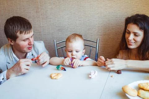 Child at the table eating candy Stock Photos