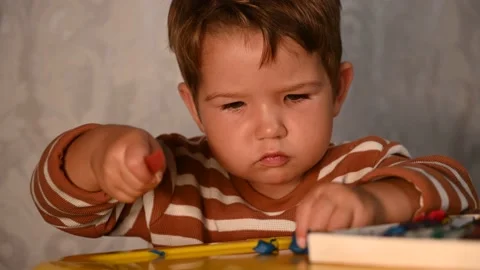 Child at the table plays plasticine. Fun educational games Stock Footage 140265331