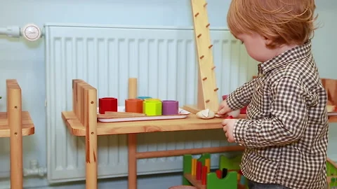 Child at the table with toys Stock Footage 144373583