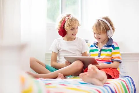 Child with tablet computer. Kids study online. Stock Photos