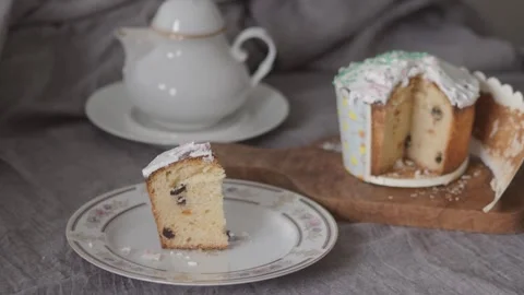 Child take icing Easter cupcake with tea Stock Footage 304661201