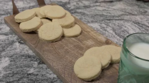 Child takes a cookie from tray - 4k Stock Footage 170907014