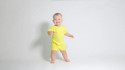 The child takes the first steps rejoicing at this Stock Footage 244846165