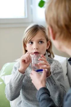 Child taking medication Stock Photos