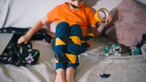 A child with taped legs lies on the sofa Stock Footage 123798780