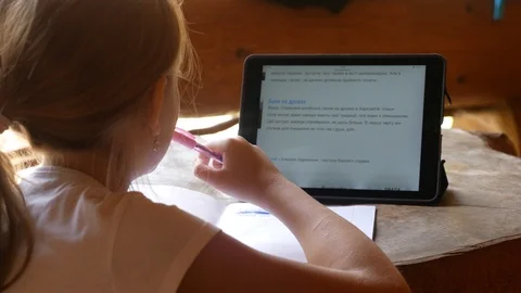 The child is teaching lessons. Tablet Stock Footage 95111224