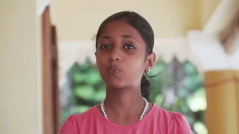 Child teases making faces shows the language and faces indian happy happiness Video stock 128502893