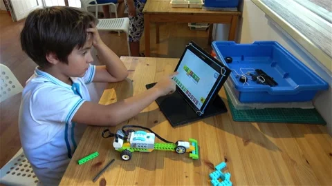 Child tests his robot car at the Robotics lesson Stock Footage 164045457