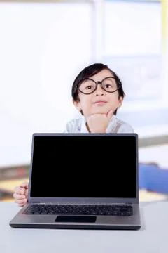 Child thinking idea with laptop in class Stock Photos