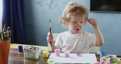 Child thinks about future picture during drawing lesson Video stock 277186665