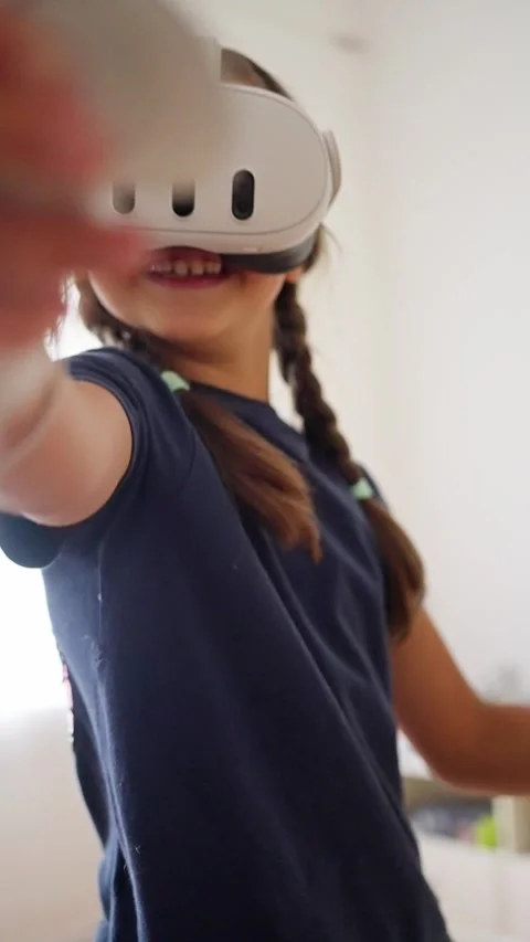 A child is thoroughly enjoying an exciting virtual reality experience right at Stock Footage 314776063