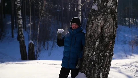 Child throwing snow over himself and enjoys it in winter park. winter Sunny day Video stock 72044637