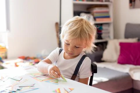 Child toddler boy playing developing games, learning alphabet and numbers, ed Stock Photos