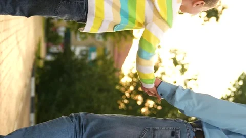 Child touching father hand sunset, family walk park sunset, child smile face Stock Footage 282889664