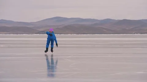 The child train on ice professional speed skating. The girl skates in the winter Stock Footage 168542284