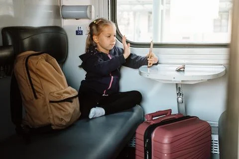 Child in train using smartphone while traveling 写真素材